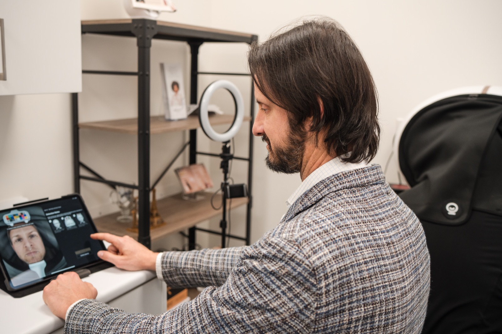 Dr. Dusan Sajic reviewing a facial skin analysis scan at deRMA Skin Institute