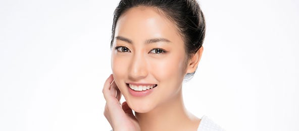 A beautiful woman is smiling after injectables treatments.