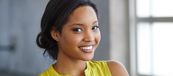 A beautiful woman is smiling after laser skin treatments.